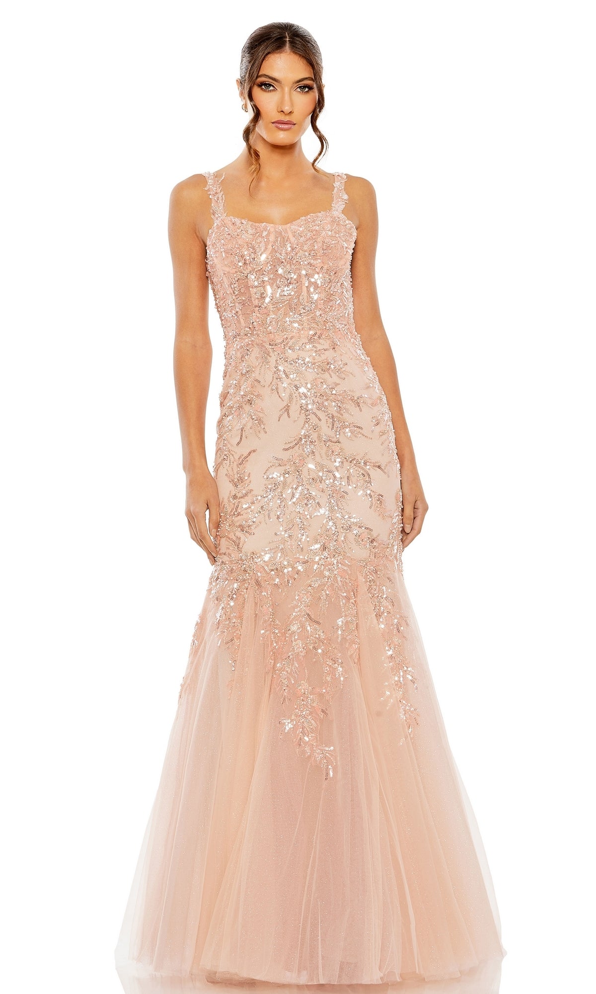 A woman wearing the Long Formal Dress 20559 by Mac Duggal—a fitted, floor-length blush pink mermaid gown with sequin and bead details, thin straps, a sweetheart neckline, and a tulle mermaid skirt.